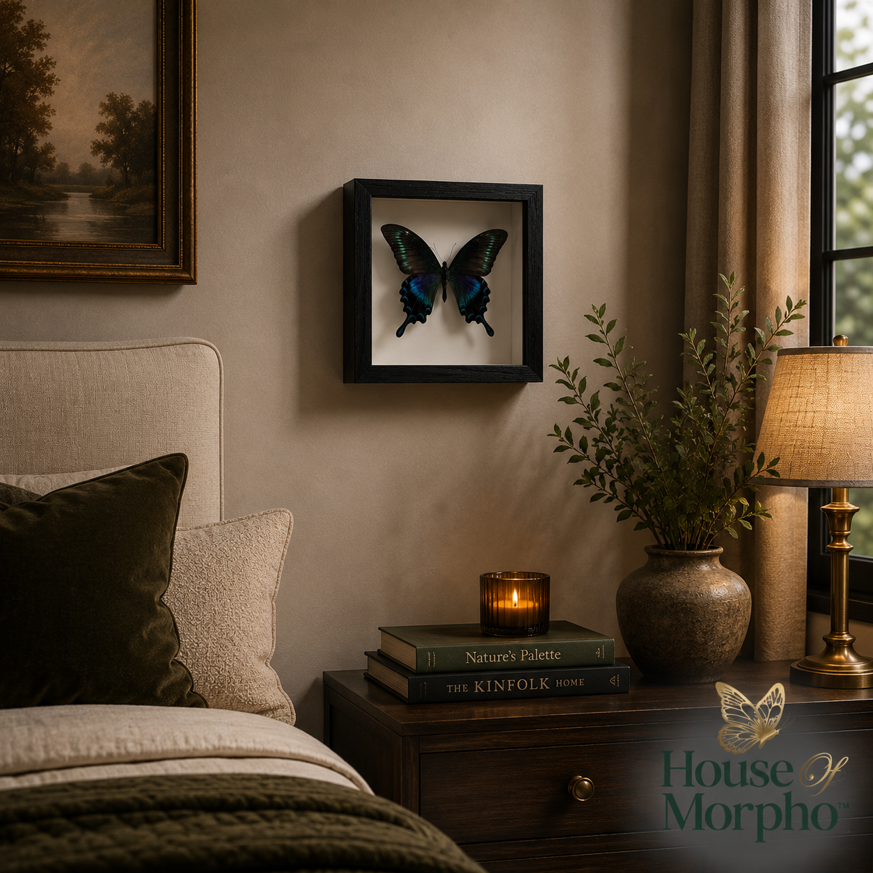 A framed black-winged butterfly wall art piece hangs on a beige bedroom wall above a wooden nightstand with a lamp, books, and a vase.